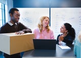Man with packaging, talking to colleagues