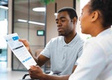 Two people discussing an invoice