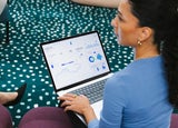 A woman works on accounting on a laptop