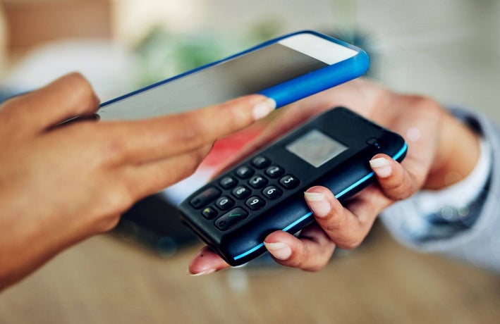 Person using a card machine to accept a mobile payment