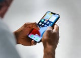 Image of an employee holding a Smartphone Texting & Calling