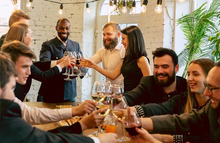 Happy co-workers celebrating while company party and corporate event