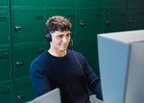 Man smiling while looking at a telephone system